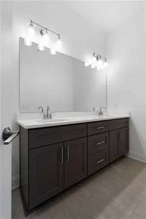 a bathroom with a double vanity sink and mirror