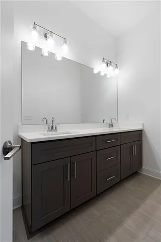 a bathroom with a double vanity sink and mirror