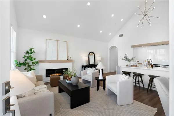 a living room with furniture a fireplace and a table