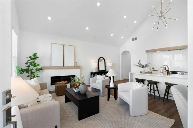 a living room with furniture a fireplace and a table