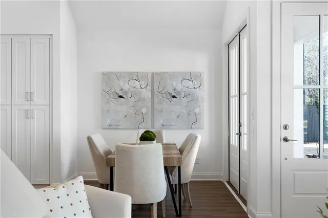 a view of a dining room with furniture and wooden floor