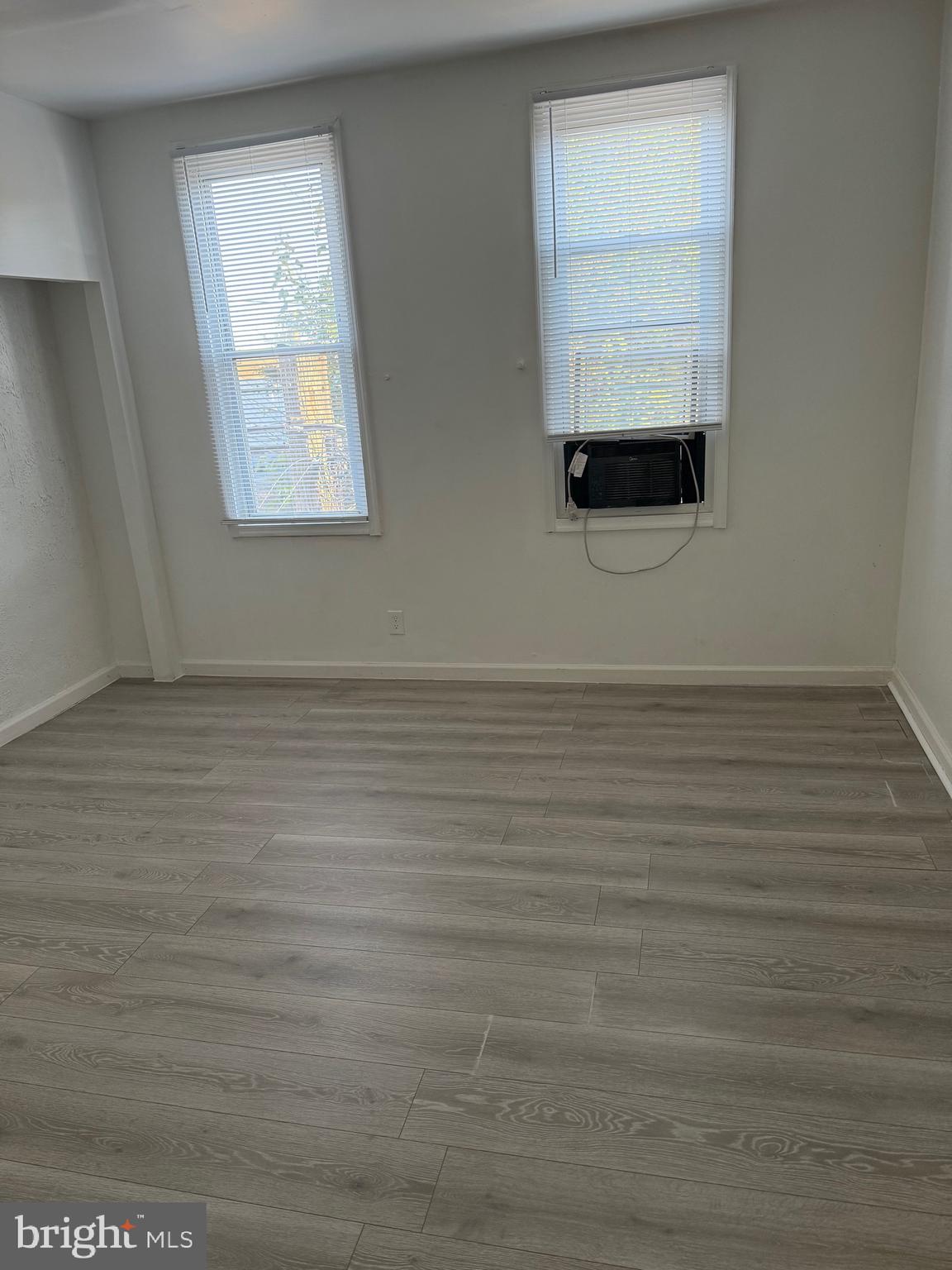 2856 Tulip Street Philadelphia, PA 19134 - Photo 12 of 13 a view of an empty room with wooden floor and a window