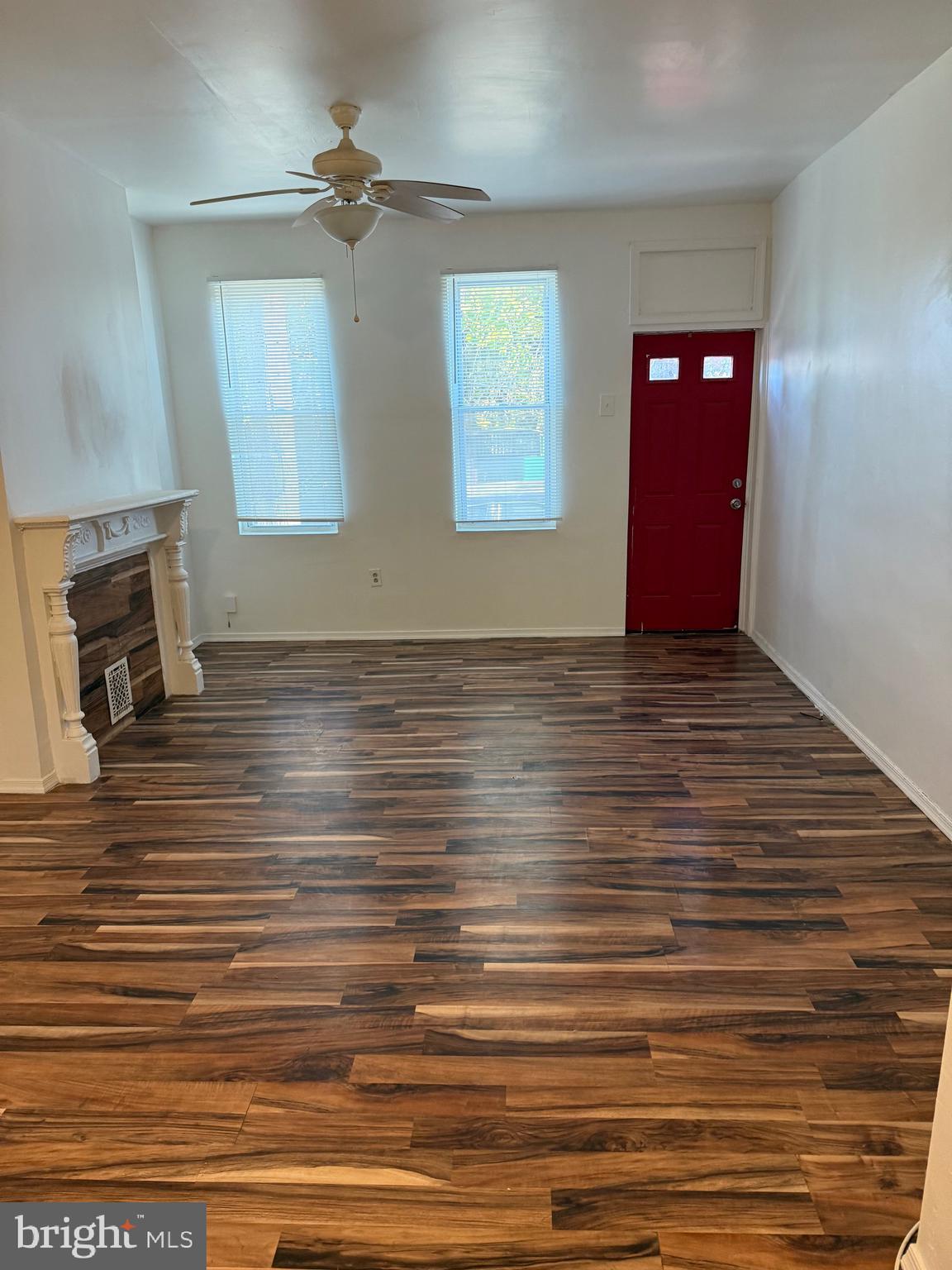2856 Tulip Street Philadelphia, PA 19134 - Photo 2 of 13 a view of an empty room with wooden floor and a fireplace