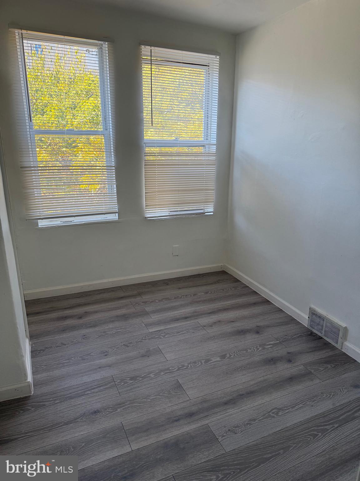 2856 Tulip Street Philadelphia, PA 19134 - Photo 7 of 13 a view of an empty room with wooden floor and a window
