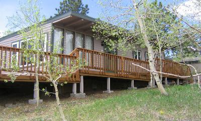 188 Timber Top Road Bailey, CO 80421 - Photo 1 of 1 a view of a house with a wooden deck and furniture