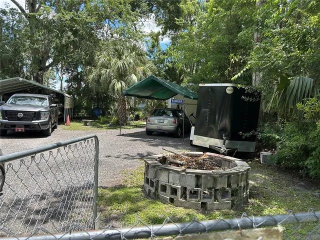 a view of a patio with table and chairs and potted plants