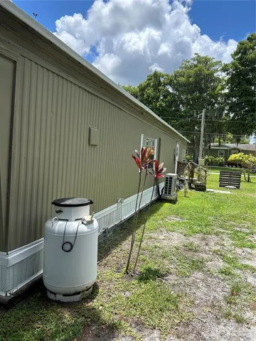 a view of a backyard with sitting area and garden