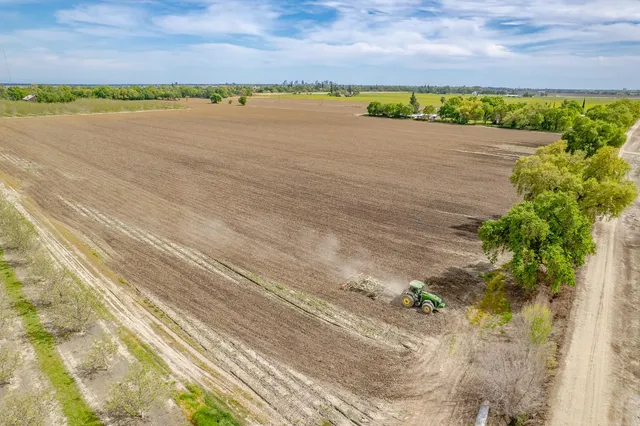 an aerial view of ocean with residential house with green space