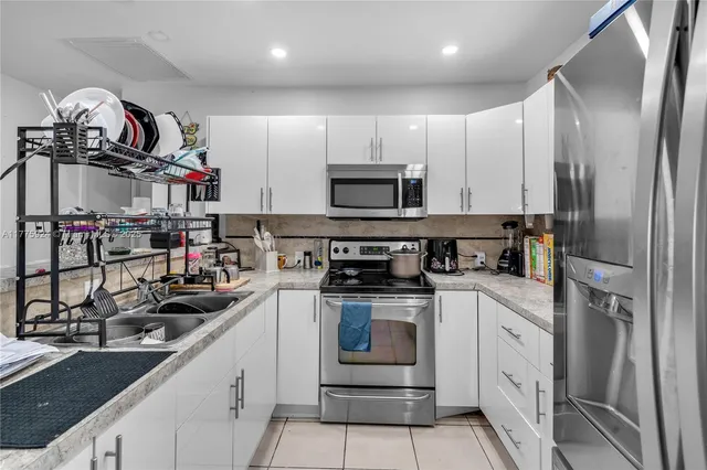a kitchen with stainless steel appliances granite countertop a sink and cabinets