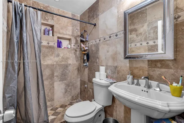 a bathroom with a sink toilet and a shower
