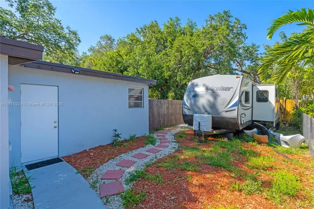 a backyard of a house with table and chairs