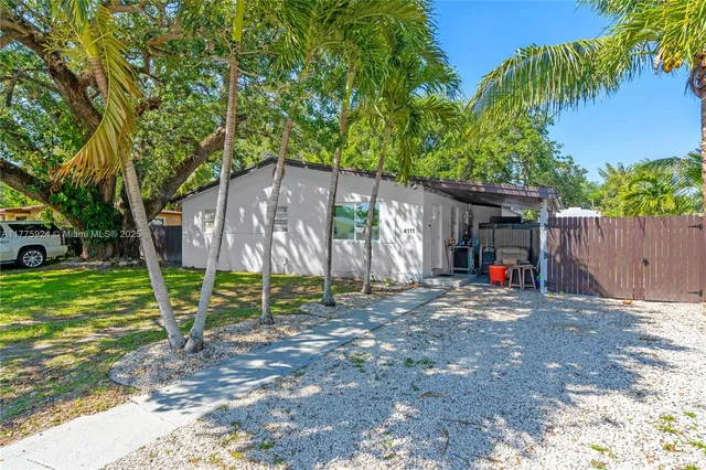 a view of a house with a yard and tree