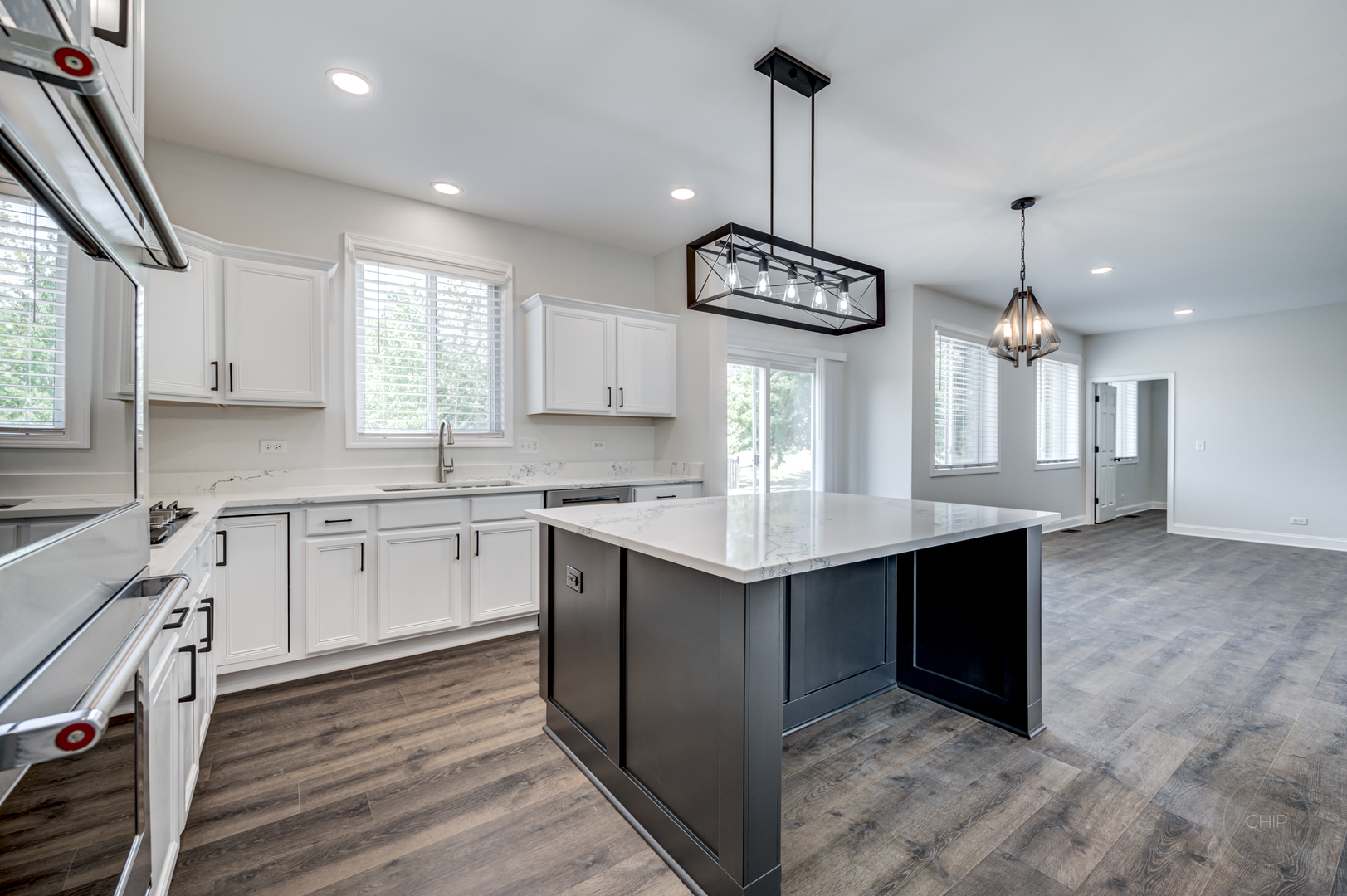 12948 Parterre Place Plainfield, IL 60585 - Photo 11 of 35 a kitchen with kitchen island granite countertop a sink cabinets and window