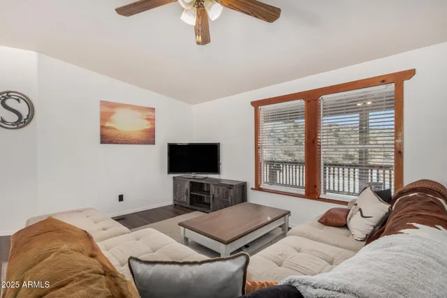 a bedroom with furniture and a flat screen tv