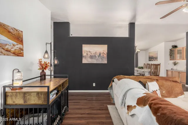 a bedroom with bed and wooden floor