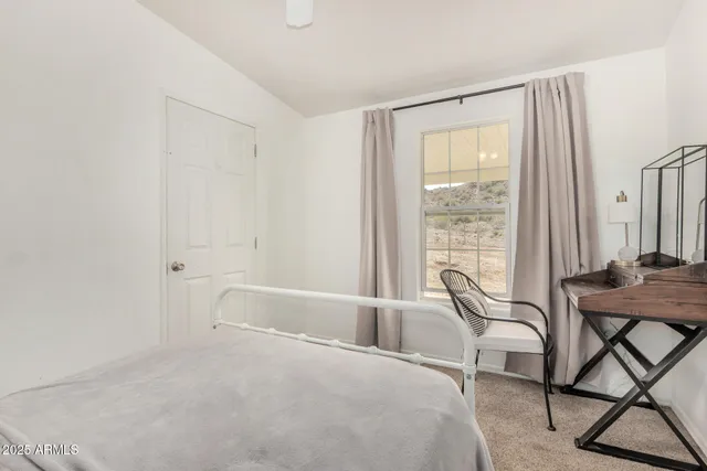 a spacious bedroom with a bed and a window