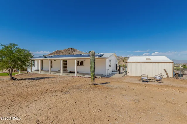 a view of a house with a yard and patio