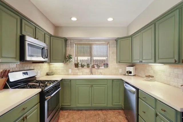 a kitchen with a sink a refrigerator and a sink
