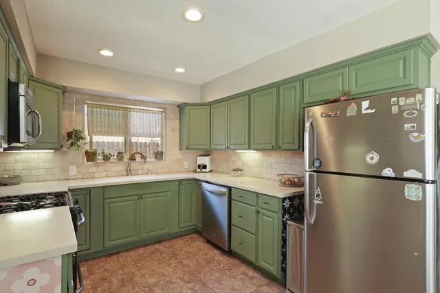 a kitchen with stainless steel appliances a stove a sink and a microwave