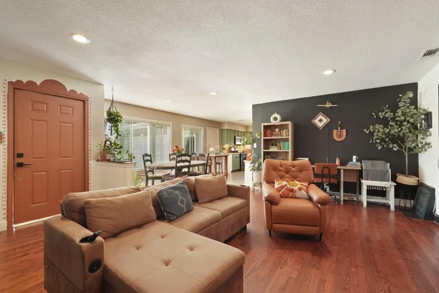 a living room with furniture a flat screen tv and a fireplace