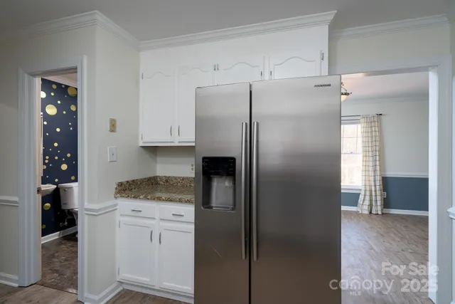 a kitchen with stainless steel appliances granite countertop a refrigerator and a stove top oven