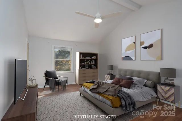 a living room with furniture wooden floor and a flat screen tv