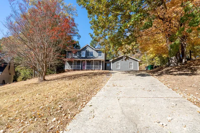 a front view of a house with a trees