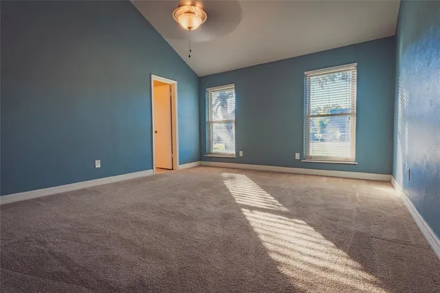 a view of a room with an empty space and wooden floor