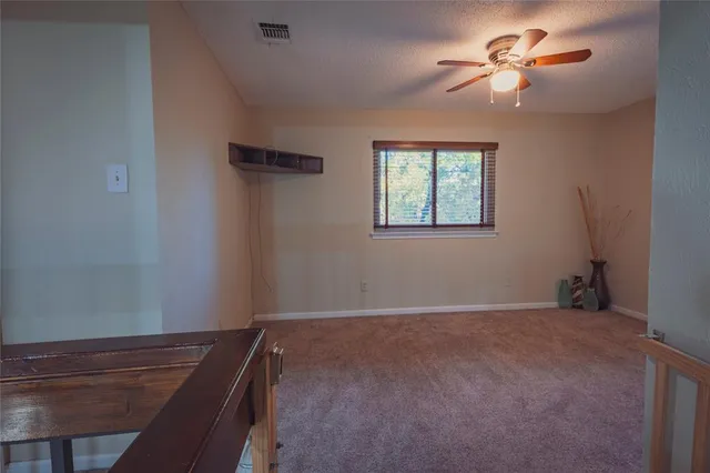 a view of empty room with a ceiling fan