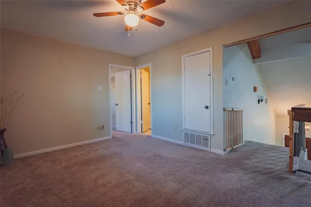 a bathroom with a granite countertop toilet sink and mirror