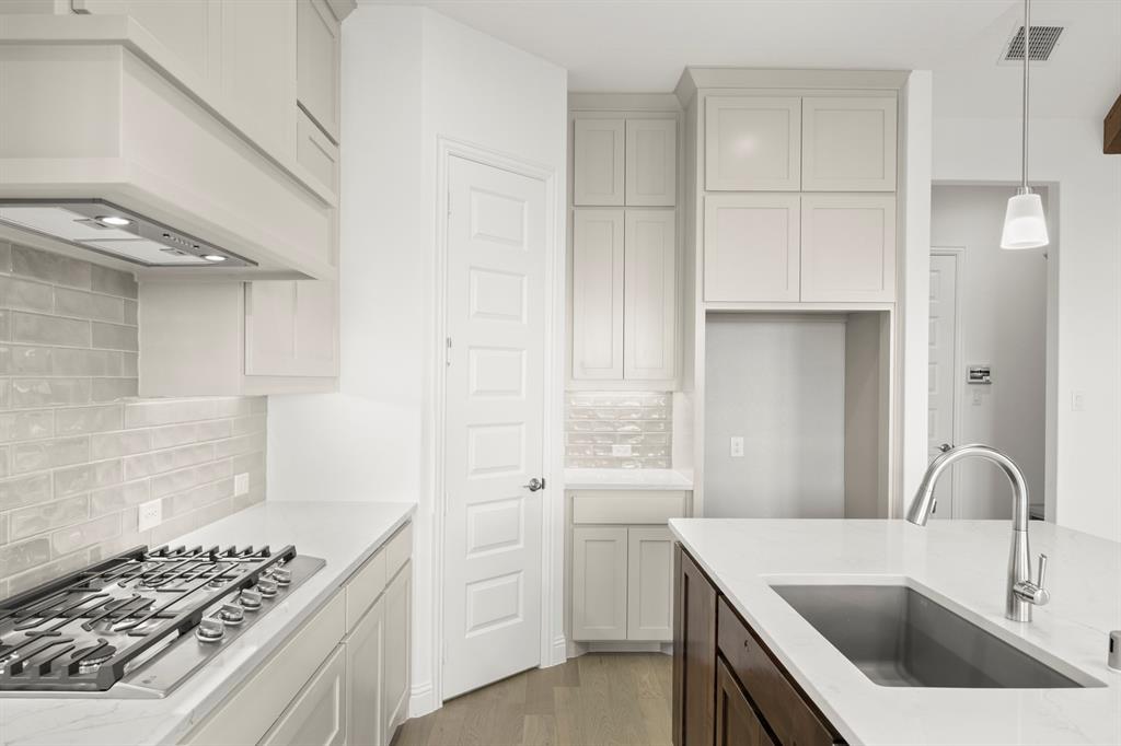 2006 Wickersham Road Rockwall, TX 75087 - Photo 11 of 33 a kitchen that has a sink and a stove