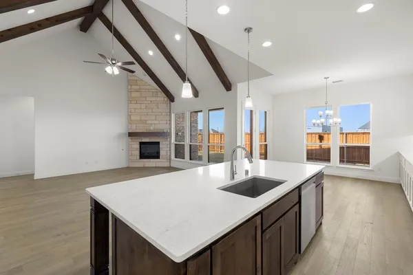 a kitchen with stainless steel appliances granite countertop a sink and a refrigerator