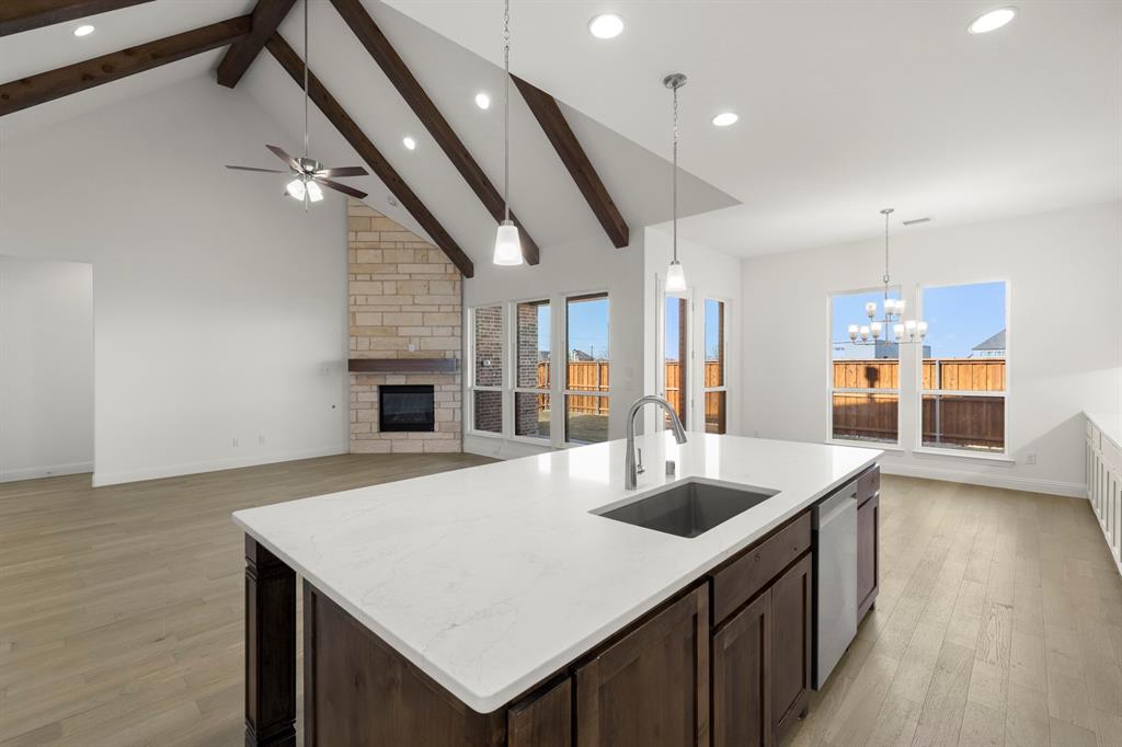 2006 Wickersham Road Rockwall, TX 75087 - Photo 12 of 33 a kitchen with stainless steel appliances granite countertop a sink and a refrigerator