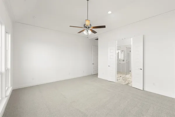 an empty room with a ceiling fan and a window
