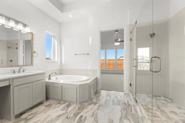 a spacious bathroom with a double vanity sink mirror and shower