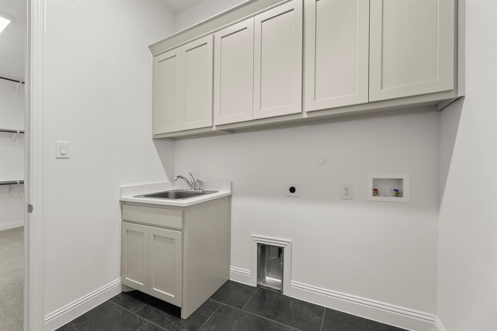 2006 Wickersham Road Rockwall, TX 75087 - Photo 24 of 33 a utility room with cabinets