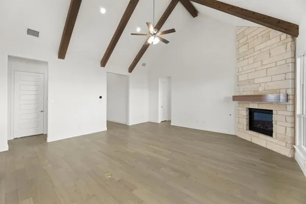 a view of an empty room with a fireplace