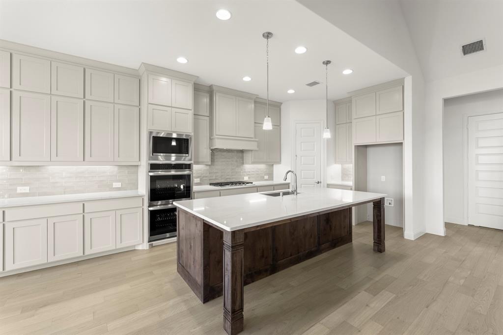 2006 Wickersham Road Rockwall, TX 75087 - Photo 10 of 33 a kitchen with a sink stove and refrigerator