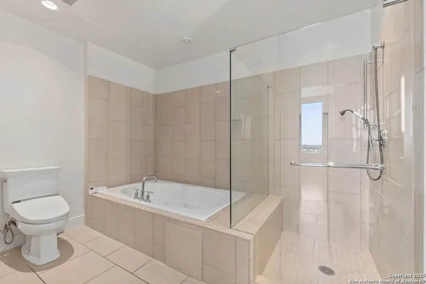 a bathroom with a bathtub and a toilet