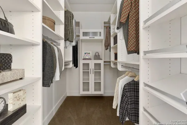 a view of a kitchen with a sink and refrigerator