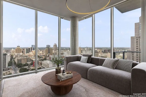 a living room with furniture and a floor to ceiling window