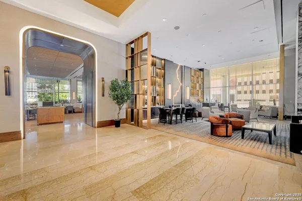 a living room with furniture and large windows