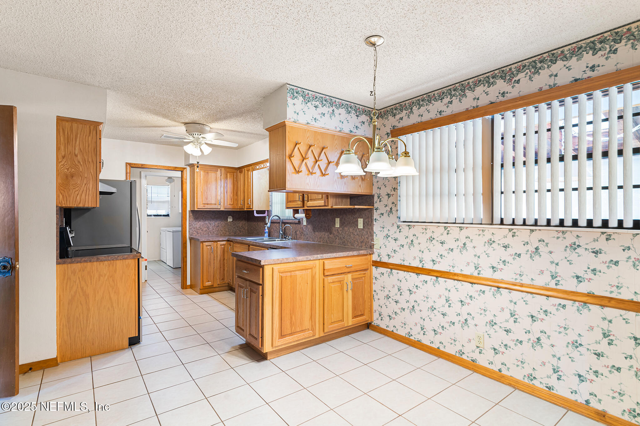 12850 Deep Lagoon Place West Jacksonville, FL 32246 - Photo 18 of 51 a large kitchen with granite countertop a stove a sink and a refrigerator