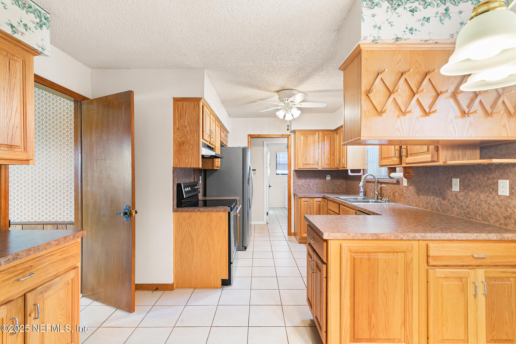 12850 Deep Lagoon Place West Jacksonville, FL 32246 - Photo 19 of 51 a kitchen with stainless steel appliances granite countertop a refrigerator and a sink