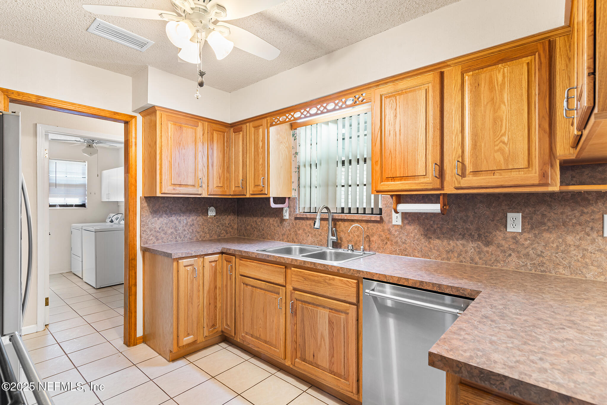 12850 Deep Lagoon Place West Jacksonville, FL 32246 - Photo 20 of 51 a kitchen with a sink dishwasher a stove and white cabinets with wooden floor