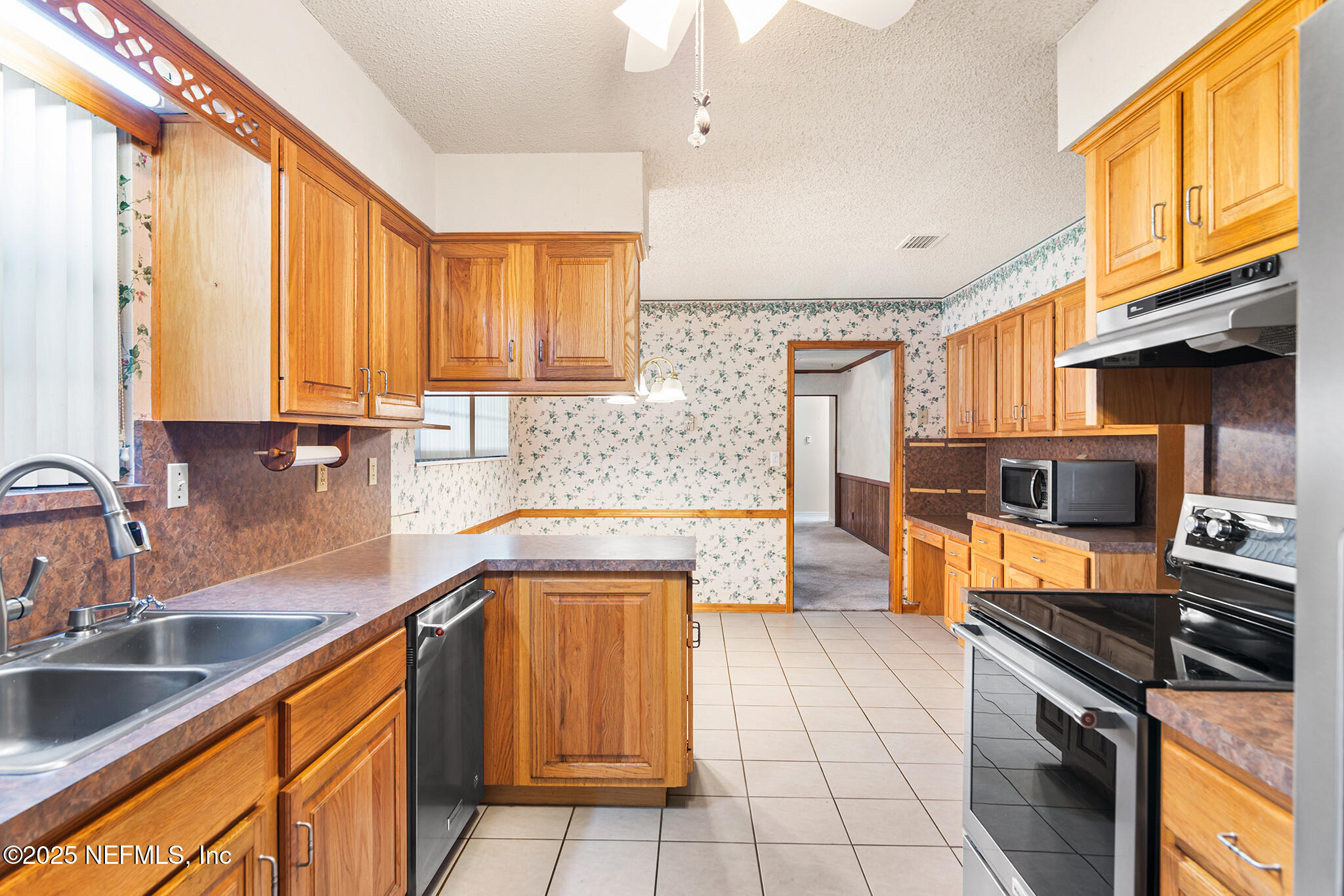 12850 Deep Lagoon Place West Jacksonville, FL 32246 - Photo 21 of 51 a kitchen with stainless steel appliances granite countertop a sink stove and refrigerator