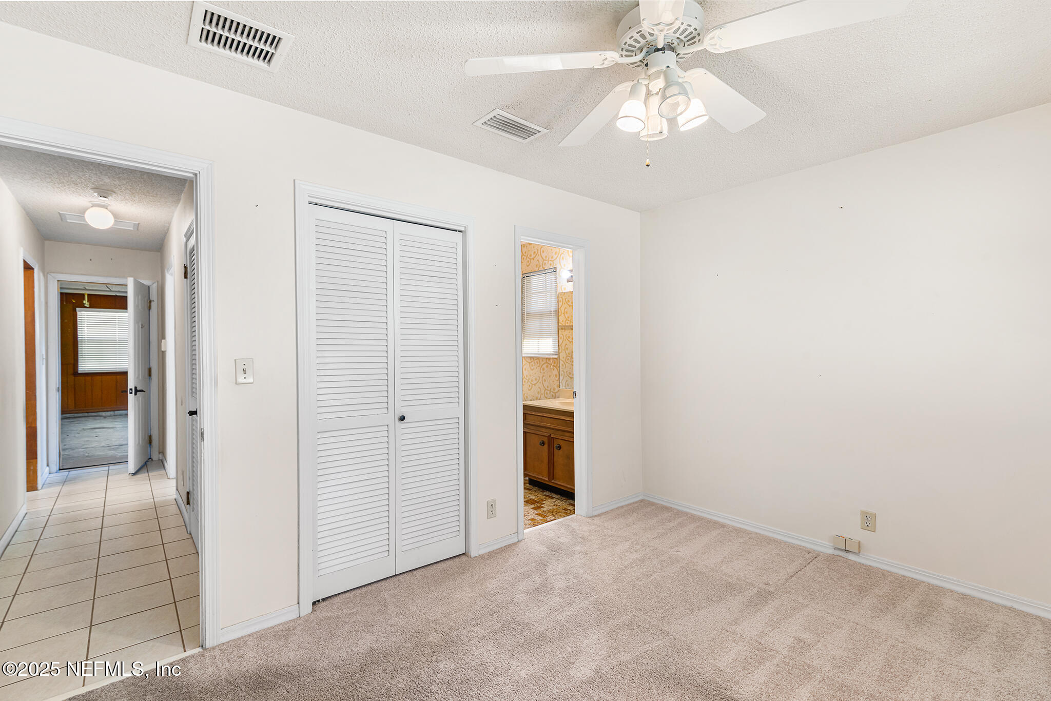 12850 Deep Lagoon Place West Jacksonville, FL 32246 - Photo 25 of 51 an empty room with a bathroom and a chandelier fan