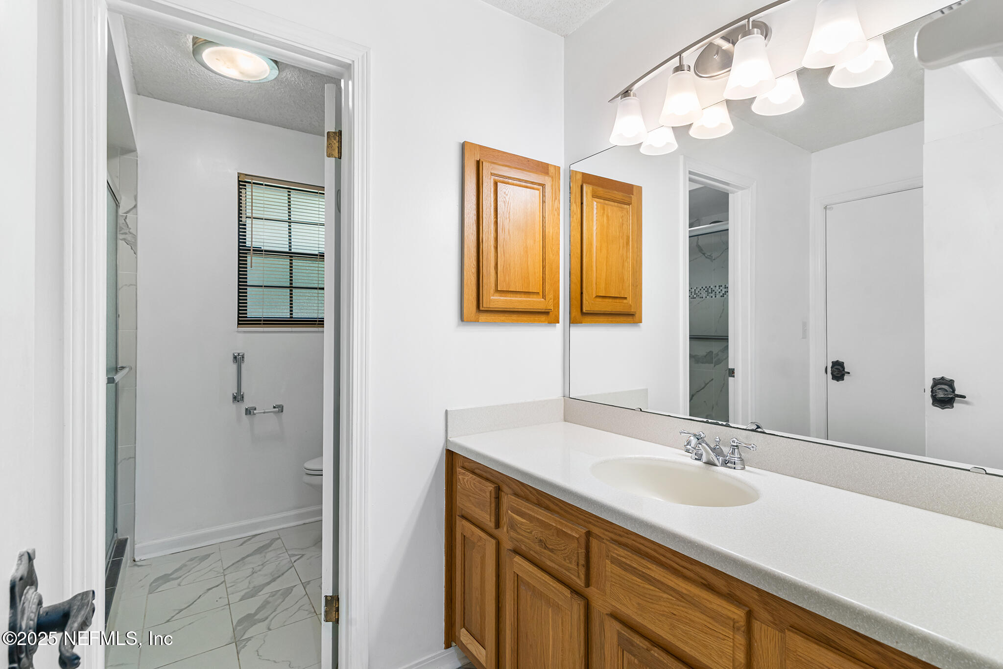 12850 Deep Lagoon Place West Jacksonville, FL 32246 - Photo 33 of 51 a bathroom with a sink double vanity and a mirror