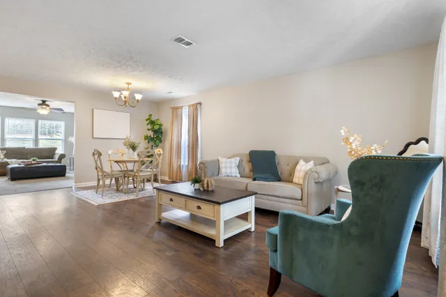 a living room with furniture and a table