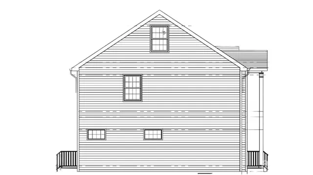 a view of a white house next to a white wall